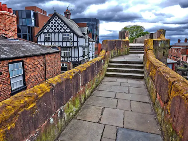 People walking on the red sandstone Chester City Walls