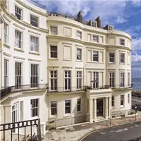 White stucco Regency townhouses facing the sea