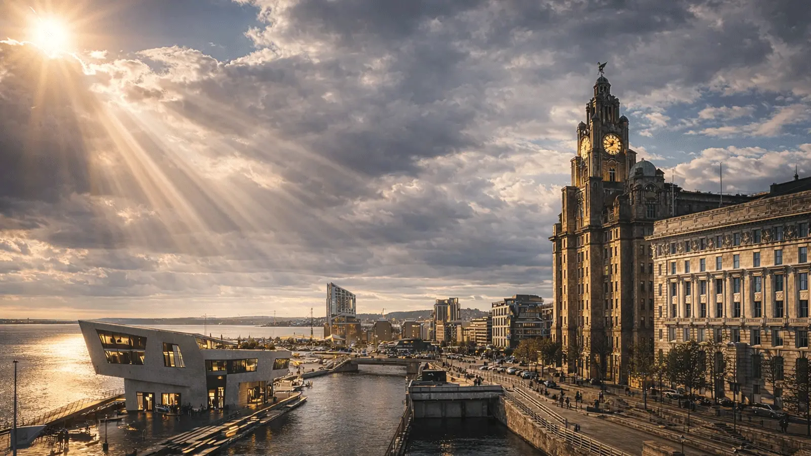 Sun rays over Liverpool’s Pier Head waterfront, with the Royal Liver Building and the Museum of Liverpool beside the River Mersey