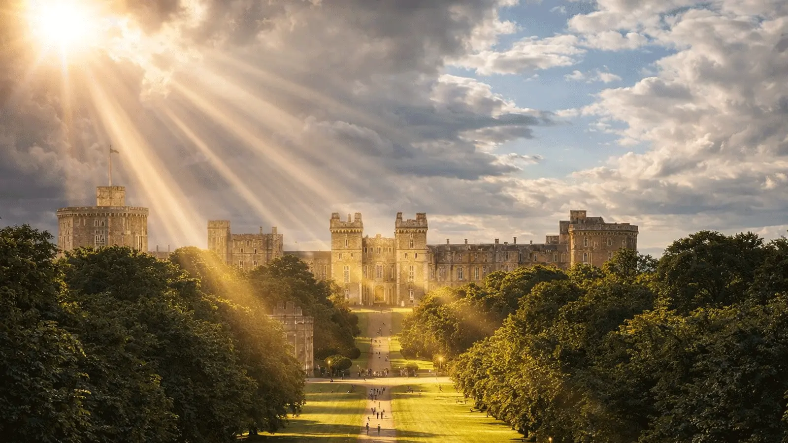 Sun rays over Windsor Castle and the Long Walk, with trees lining the avenue